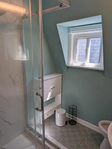 a bathroom with a toilet and a window