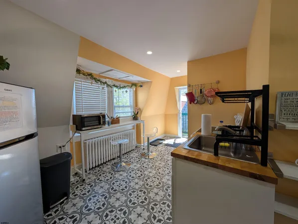 a kitchen that has a sink and a wooden floor