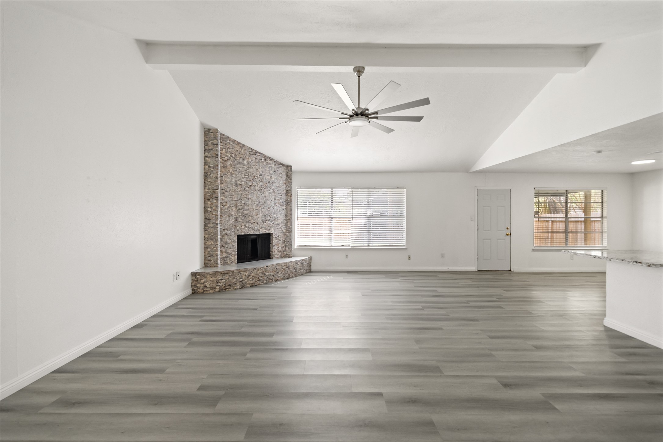 5726 Yorkgate Drive Spring, TX 77373 - Photo 6 of 20 wooden floor in an empty room with a fireplace