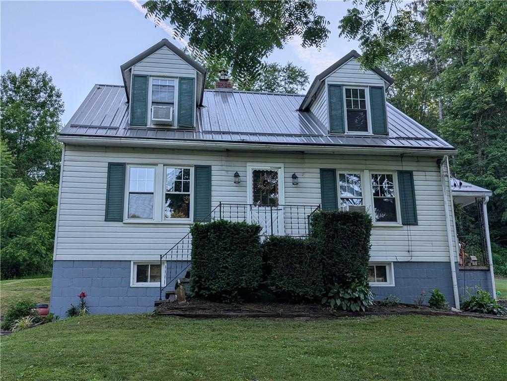 205 Woods Road Ligonier, PA 15658 - Photo 23 of 32 a front view of a house with a garden