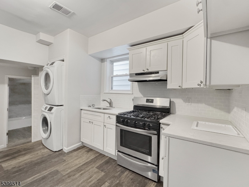 511 South Main Street, Unit 2 Phillipsburg, NJ 08865 - Photo 3 of 9 a kitchen with granite countertop cabinets stainless steel appliances and a wooden floor