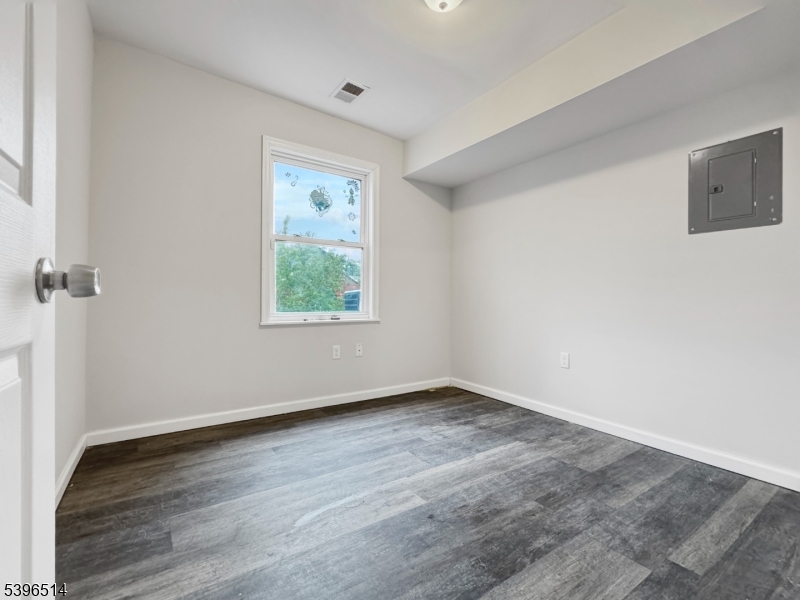 511 South Main Street, Unit 2 Phillipsburg, NJ 08865 - Photo 7 of 9 an empty room with wooden floor and window