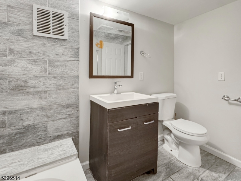 511 South Main Street, Unit 2 Phillipsburg, NJ 08865 - Photo 8 of 9 a bathroom with a sink toilet and mirror