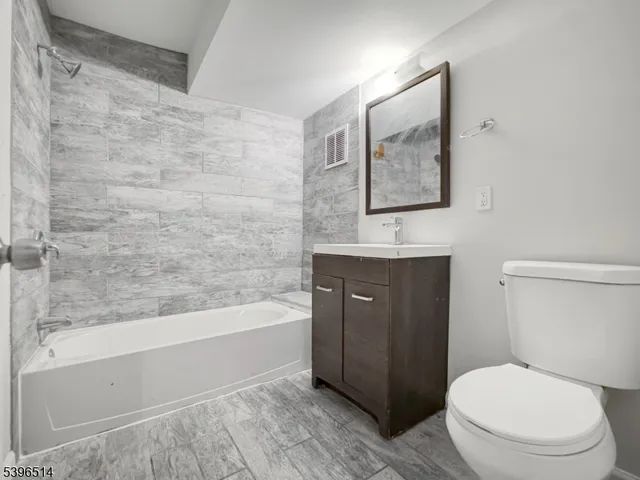 a bathroom with a toilet a sink and bathtub