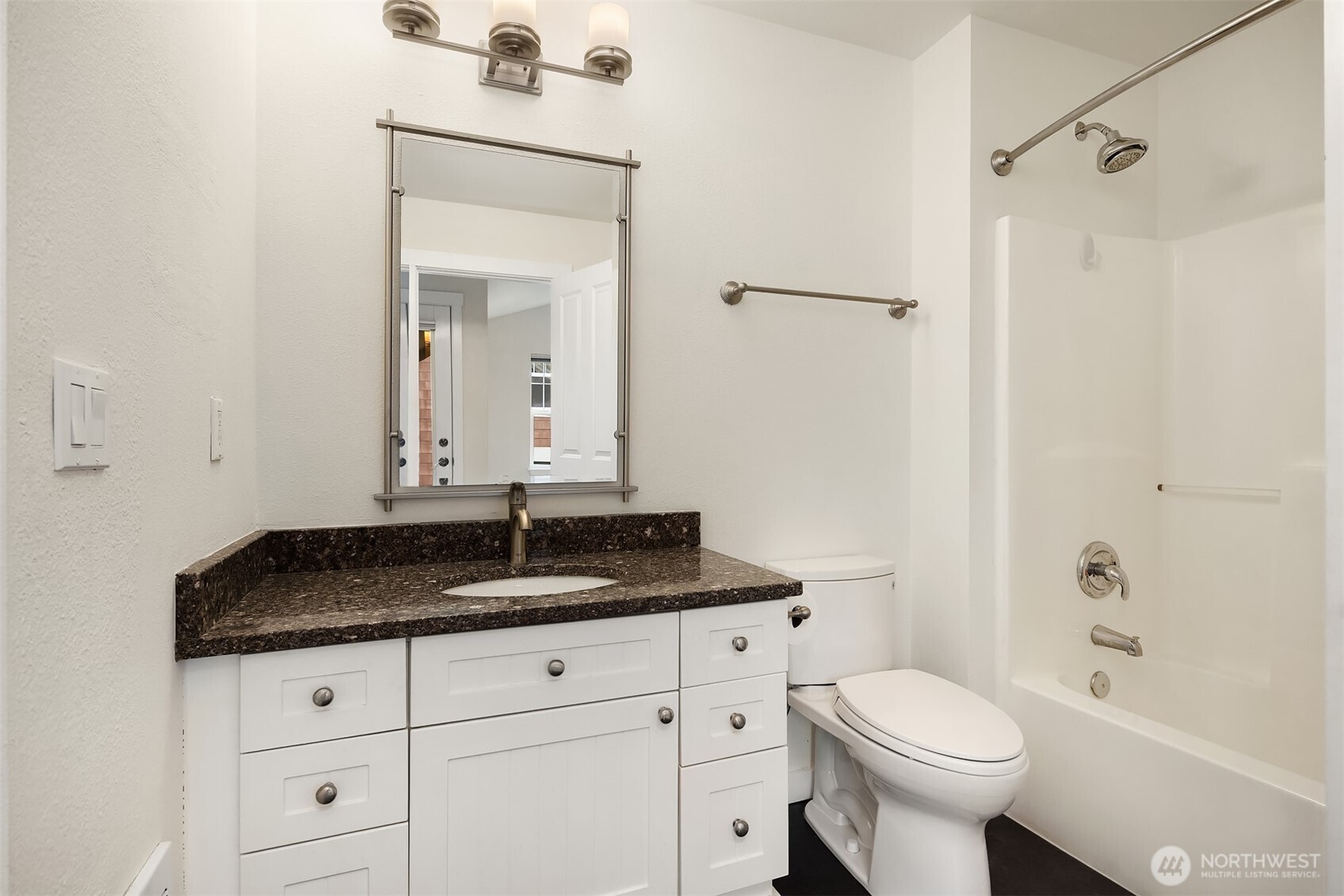 5430 California Avenue Southwest, Unit 2D Seattle, WA 98136 - Photo 18 of 26 a bathroom with a granite countertop sink toilet and shower