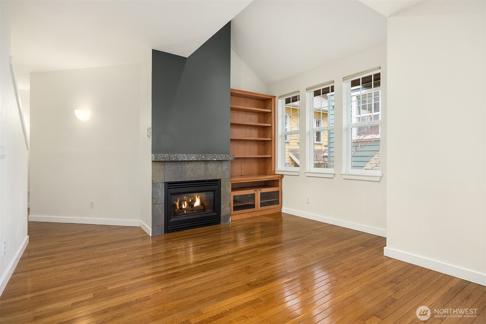 5430 California Avenue Southwest, Unit 2D Seattle, WA 98136 - Photo 8 of 26 a view of a livingroom with a fireplace and wooden floor