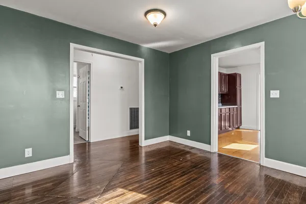 a view of an empty room and wooden floor