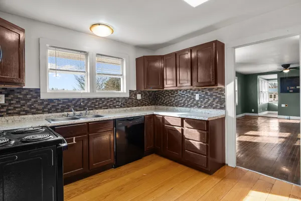 a kitchen with granite countertop a refrigerator and a sink