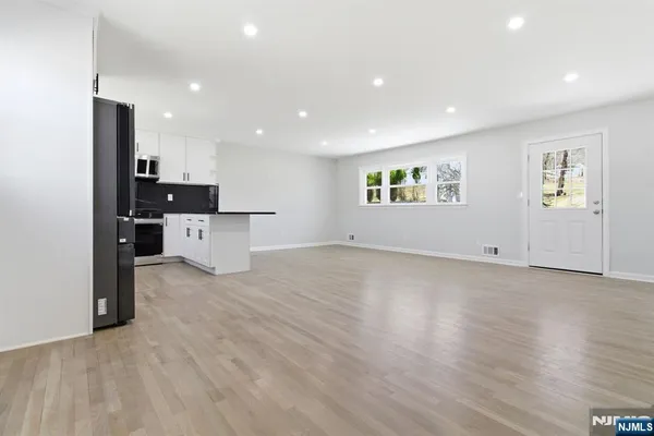 a view of a kitchen with a sink and a refrigerator
