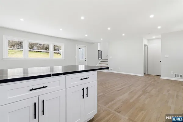 a view of kitchen with center island and stainless steel appliances
