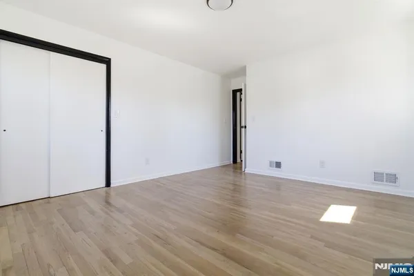 a view of a room with wooden floor