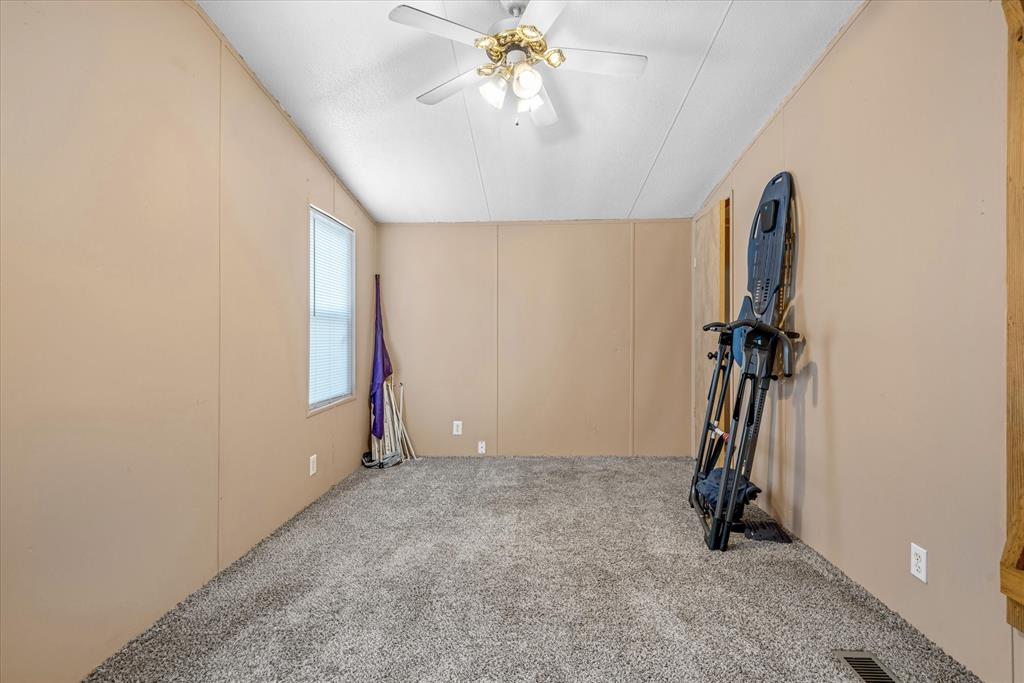 356 Farm To Market Road 751 Wills Point, TX 75169 - Photo 15 of 31 an empty room with chandelier fan and windows