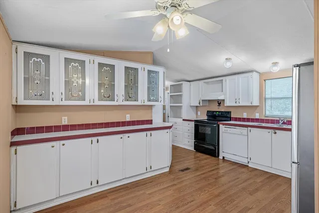 a kitchen with stainless steel appliances granite countertop a stove and a sink