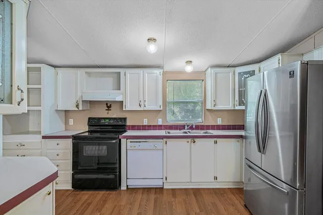 a kitchen with a sink stove and refrigerator