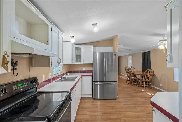 a kitchen with stainless steel appliances a refrigerator and a stove top oven