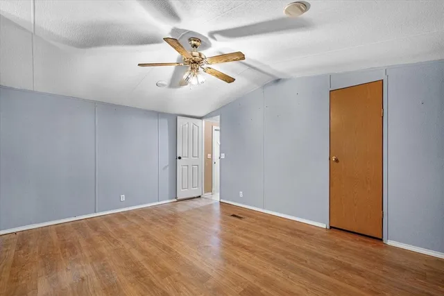 a view of an empty room and wooden floor