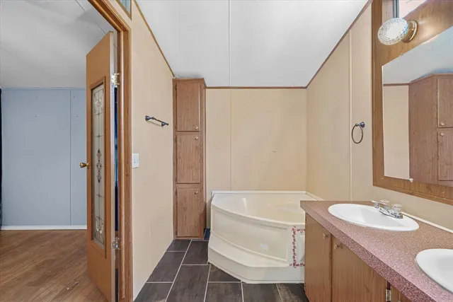 a bathroom with a sink a toilet a tub and shower