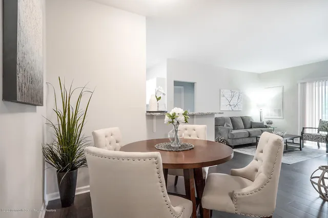 a dining room with furniture and wooden floor