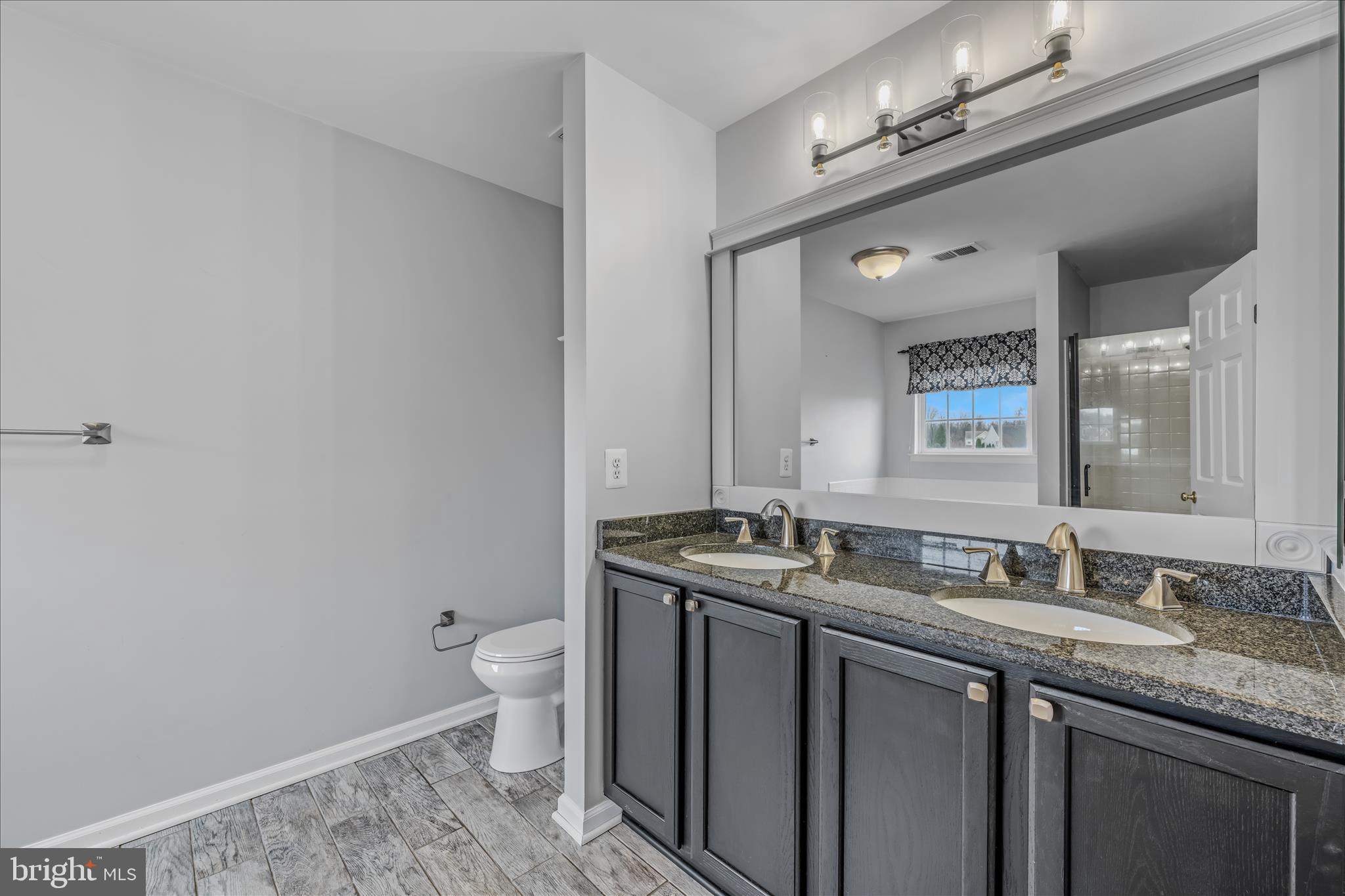 109 Turnberry Drive Charles Town, WV 25414 - Photo 26 of 77 a bathroom with a granite countertop sink a toilet and a mirror