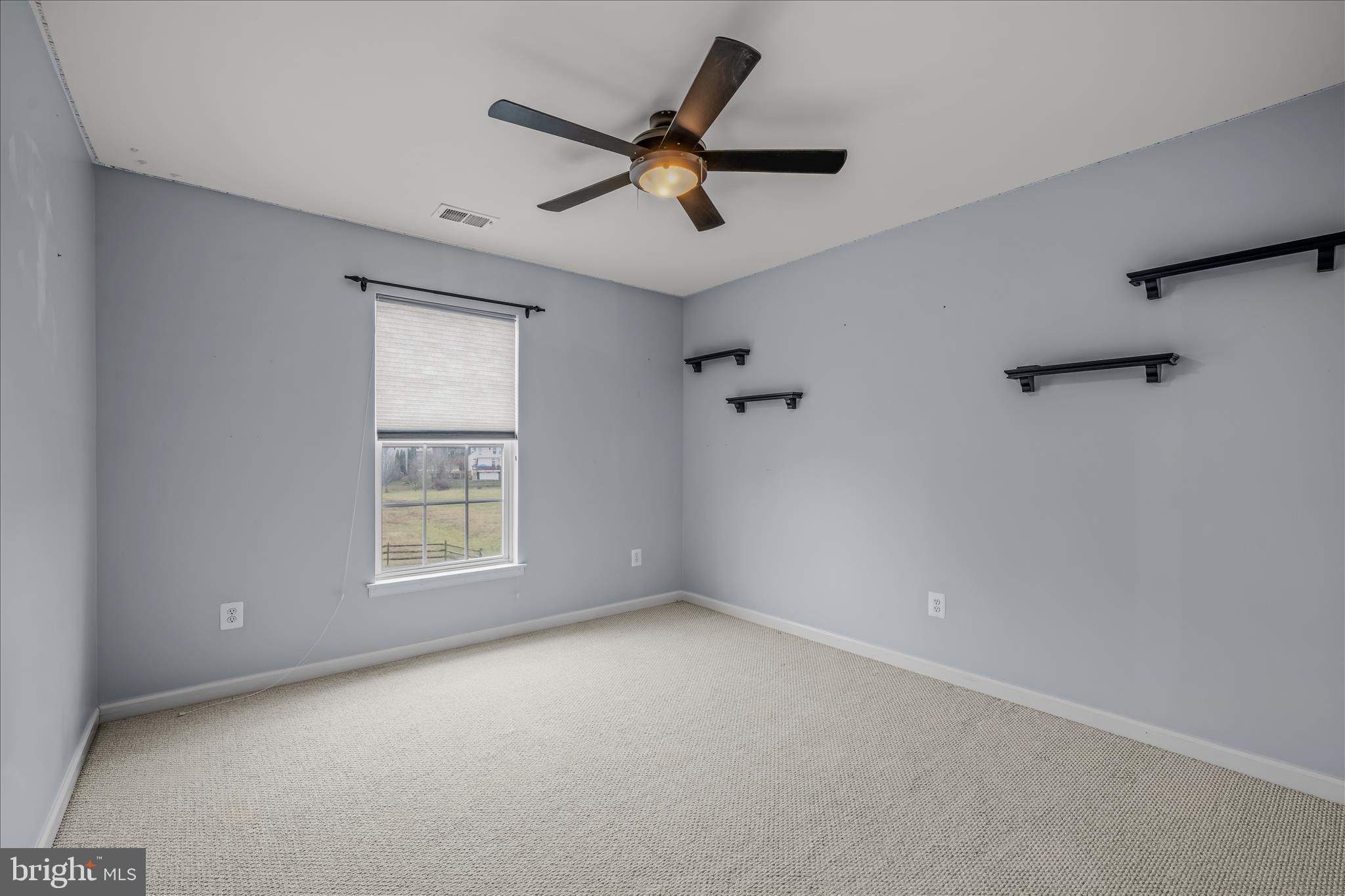 109 Turnberry Drive Charles Town, WV 25414 - Photo 33 of 77 an empty room with a window and a ceiling fan