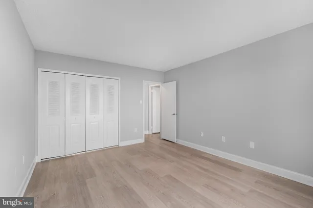 a view of an empty room and wooden floor