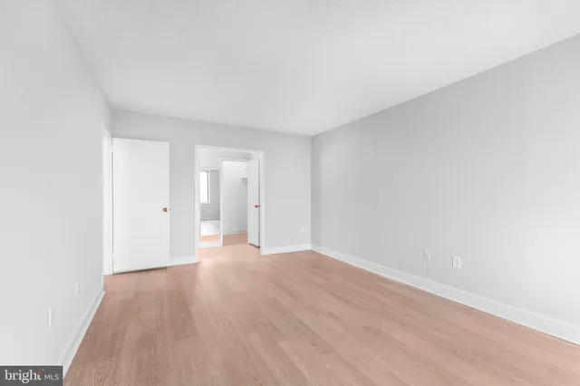 a view of an empty room and wooden floor