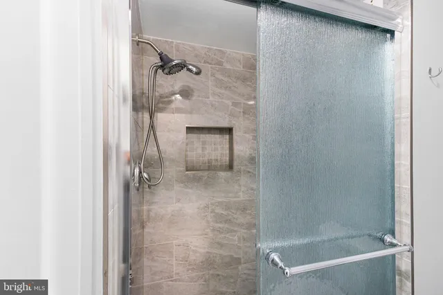 a bathroom with a glass shower door