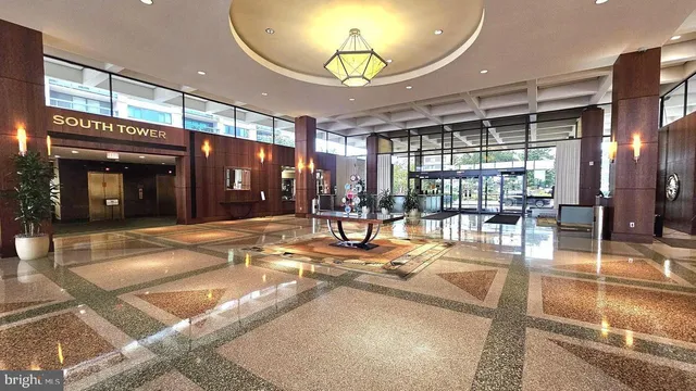 a view of a lobby with furniture and chandelier