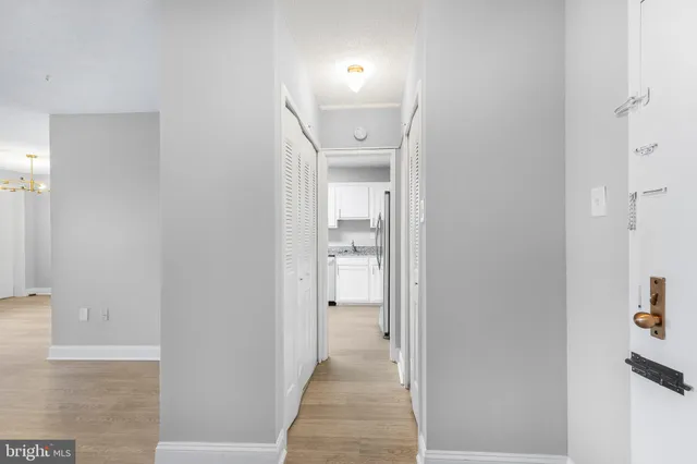 a view of a hallway with wooden shelves