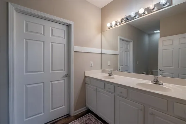 a bathroom with a double vanity sink and a mirror