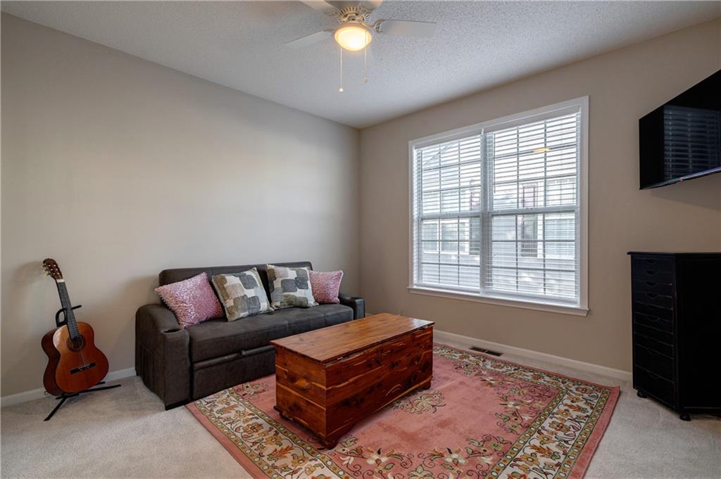 326 Camry Circle Dallas, GA 30157 - Photo 14 of 31 a living room with furniture and a flat screen tv