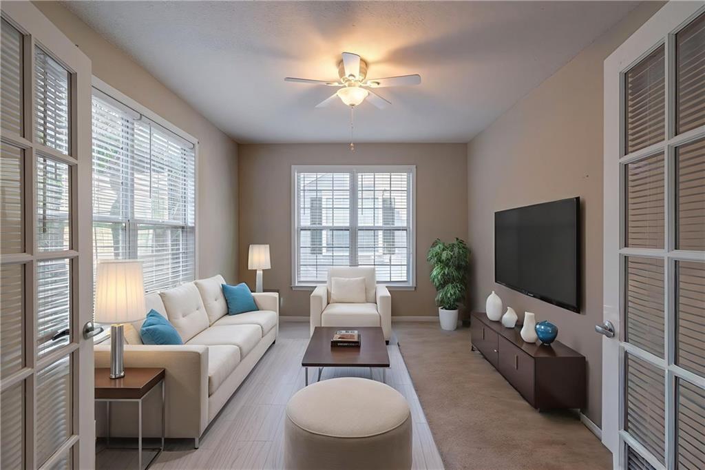 326 Camry Circle Dallas, GA 30157 - Photo 17 of 31 a living room with furniture a flat screen tv and a large window