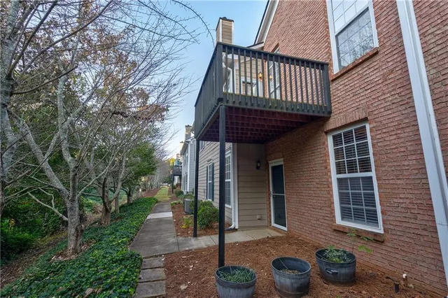 a front view of a house with garden and plants