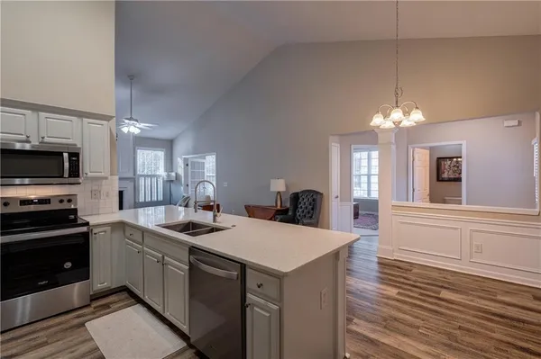 a kitchen with a sink stove and microwave