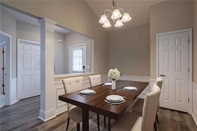 a view of a dining room with furniture wooden floor and chandelier