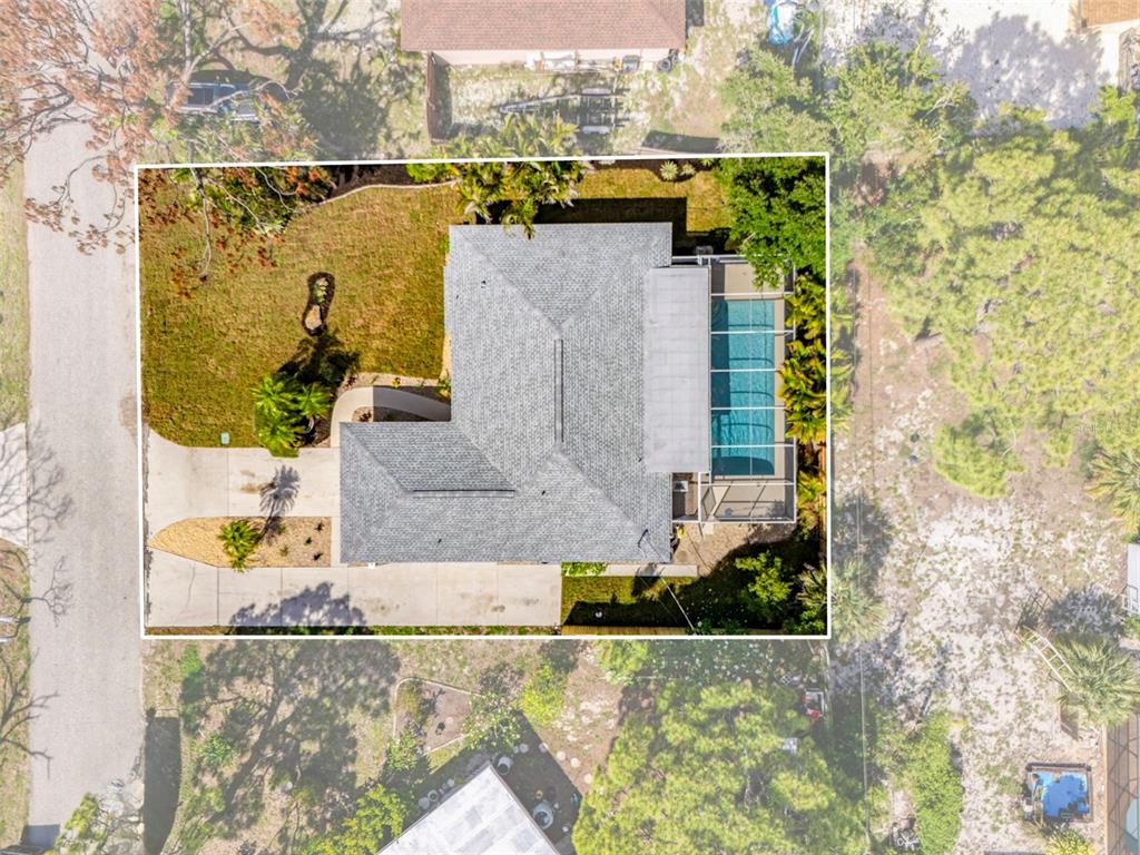 aerial view of a house with a yard and sitting area