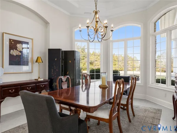 a view of a dining room with furniture wooden floor and chandelier
