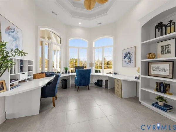 a large living room with furniture a rug and a window