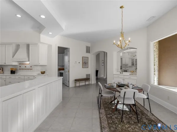 a large kitchen with sink and refrigerator