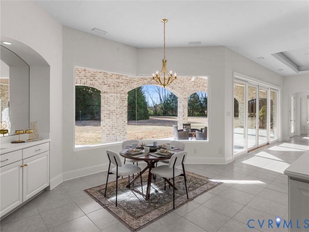 15219 Deep Spring Drive Montpelier, VA 23192 - Photo 20 of 51 a view of a dining room and livingroom with furniture wooden floor a chandelier