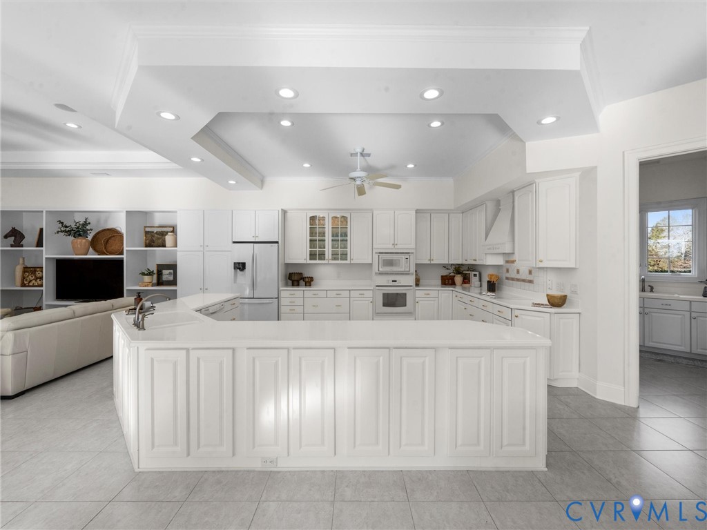 15219 Deep Spring Drive Montpelier, VA 23192 - Photo 22 of 51 a large white kitchen with lots of counter space and stainless steel appliances