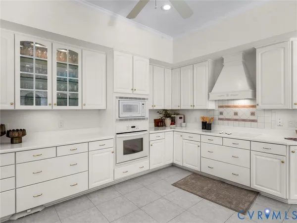 a kitchen with white cabinets and white appliances