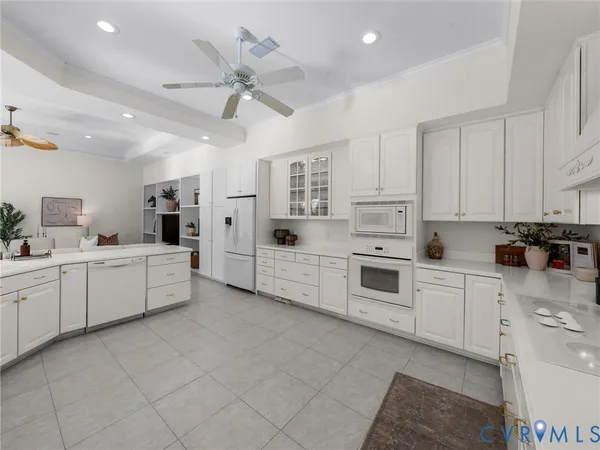a kitchen with white cabinets and white appliances