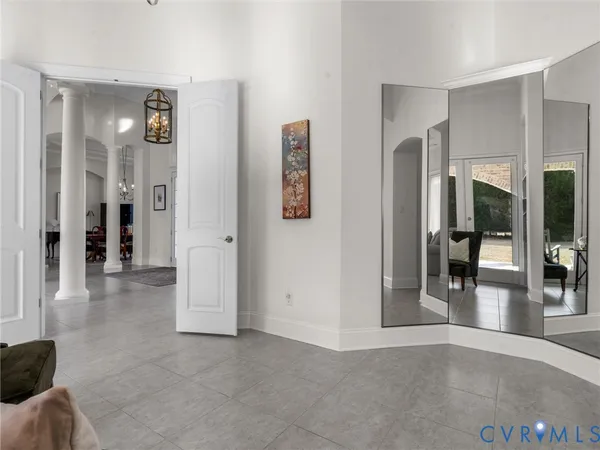a view of a hallway with wooden floor and windows