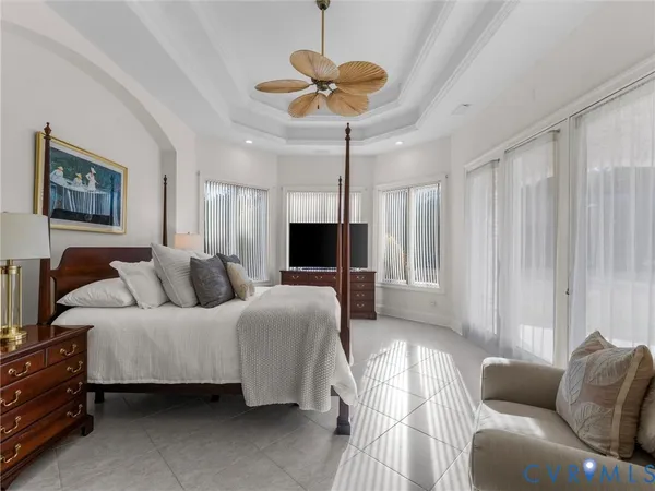 a living room with furniture a chandelier and a flat screen tv