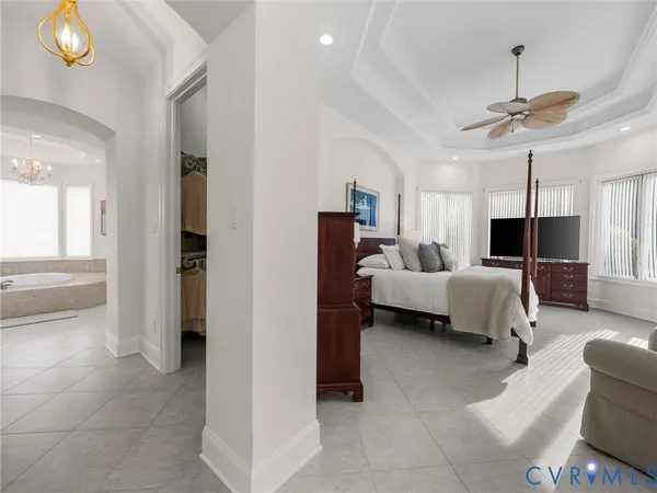 a bedroom with furniture and a chandelier