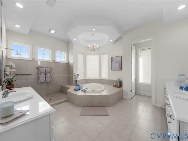 a bathroom with a sink a toilet a mirror and bathtub