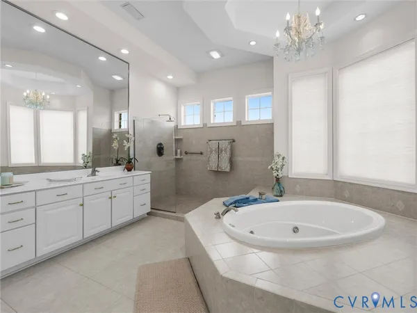 a bathroom with a granite countertop sink a large mirror and shower