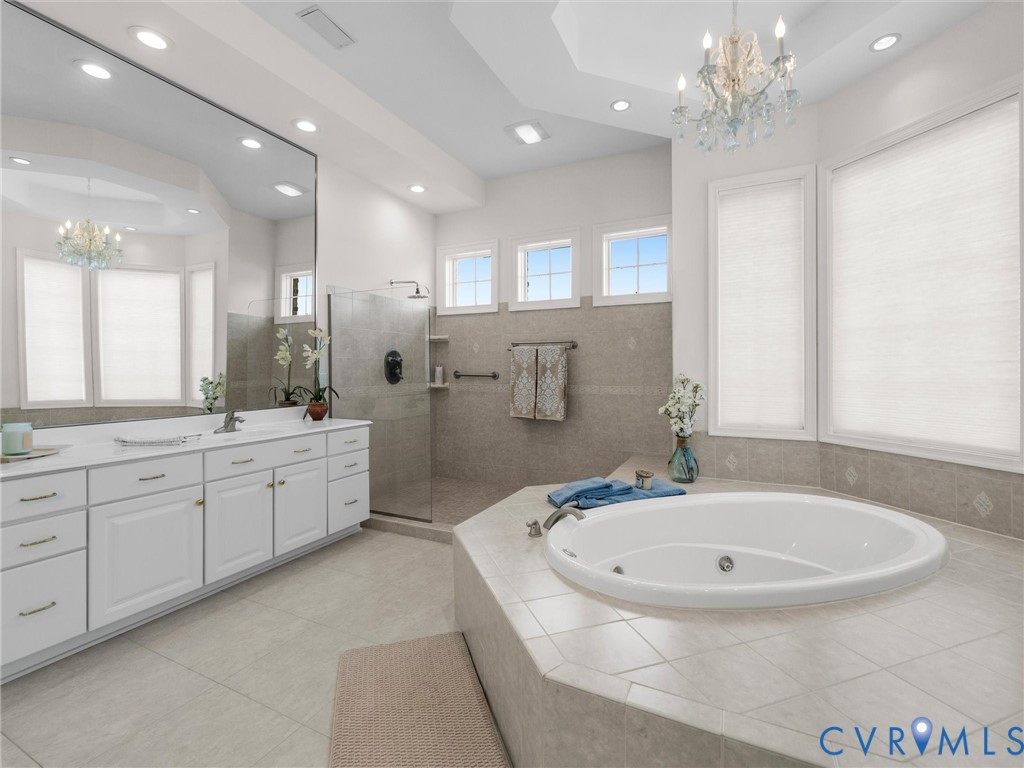 15219 Deep Spring Drive Montpelier, VA 23192 - Photo 36 of 51 a bathroom with a granite countertop sink a large mirror and shower