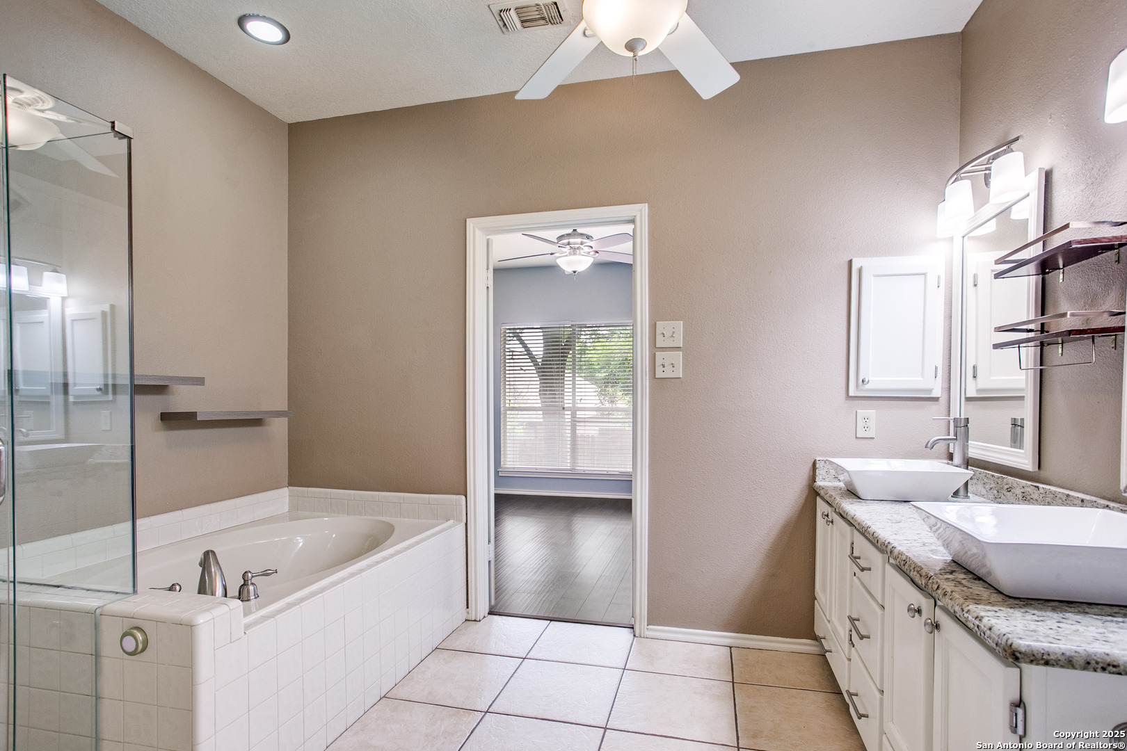 5834 Spring Crossing San Antonio, TX 78247 - Photo 13 of 29 a bathroom with a granite countertop sink a toilet and bathtub